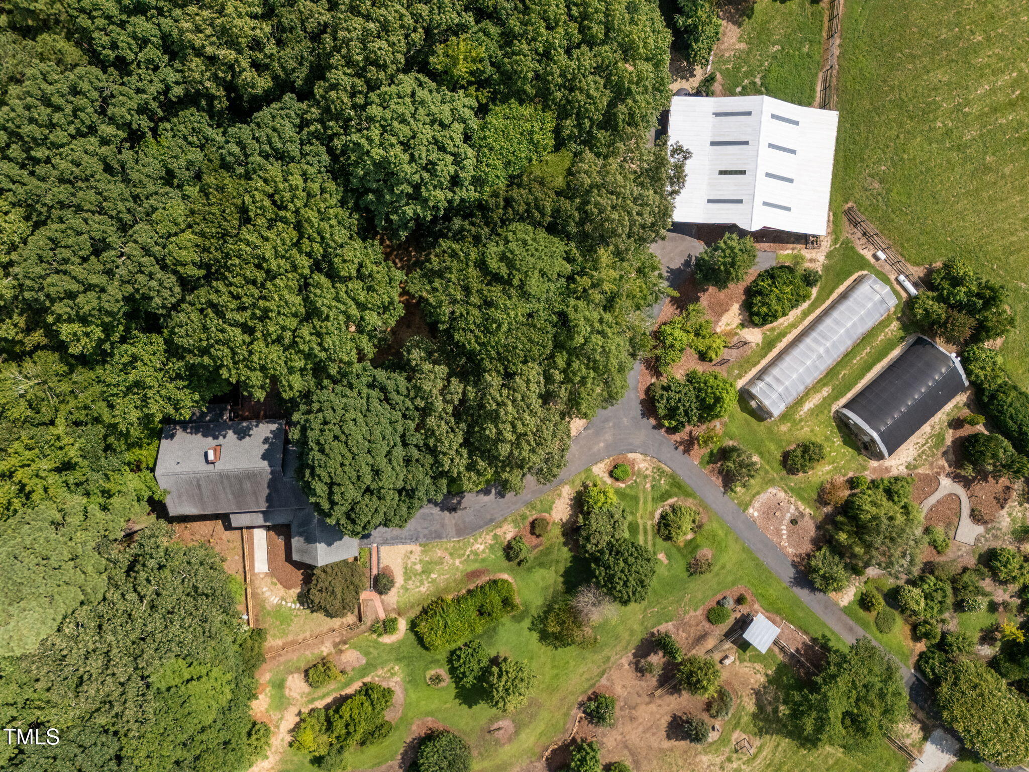 4811 New Sharon Church Road Hillsborough, NC 27278 - Photo 80 of 84 an aerial view of a house with a yard and trees all around