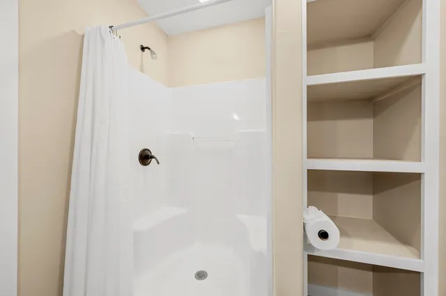 a bathroom with a glass shower door