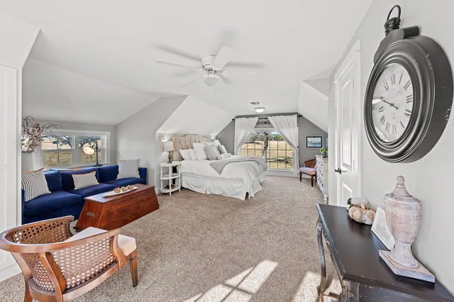 a living room with furniture a clock and a view of entryway