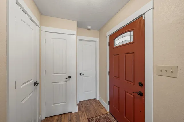 a view of a hallway with wooden floor