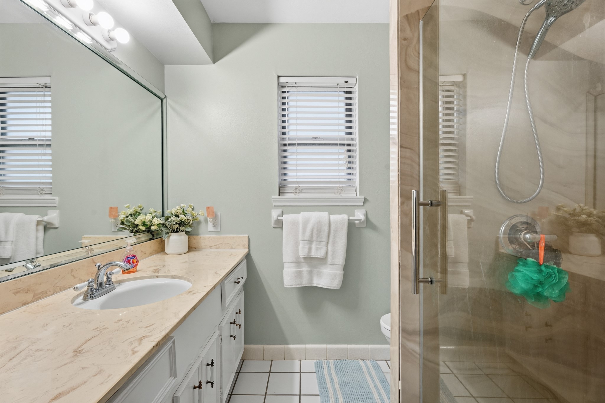 2104 Rose Road Pearland, TX 77581 - Photo 40 of 43 a bathroom with a granite countertop sink a shower and a mirror