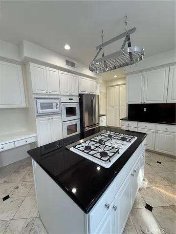 a kitchen with a stove and a refrigerator
