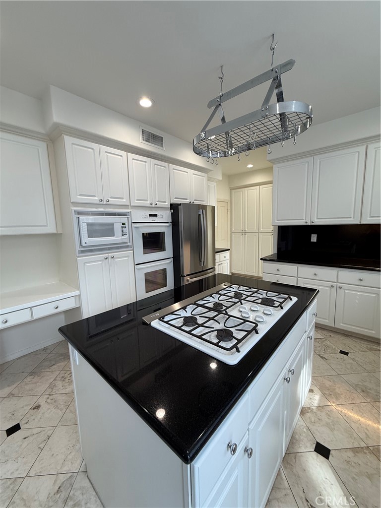 6 Ponte Irvine, CA 92606 - Photo 3 of 24 Double ovens and a pot rack compliment the kitchen.