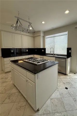 a kitchen with stainless steel appliances granite countertop a sink and a stove