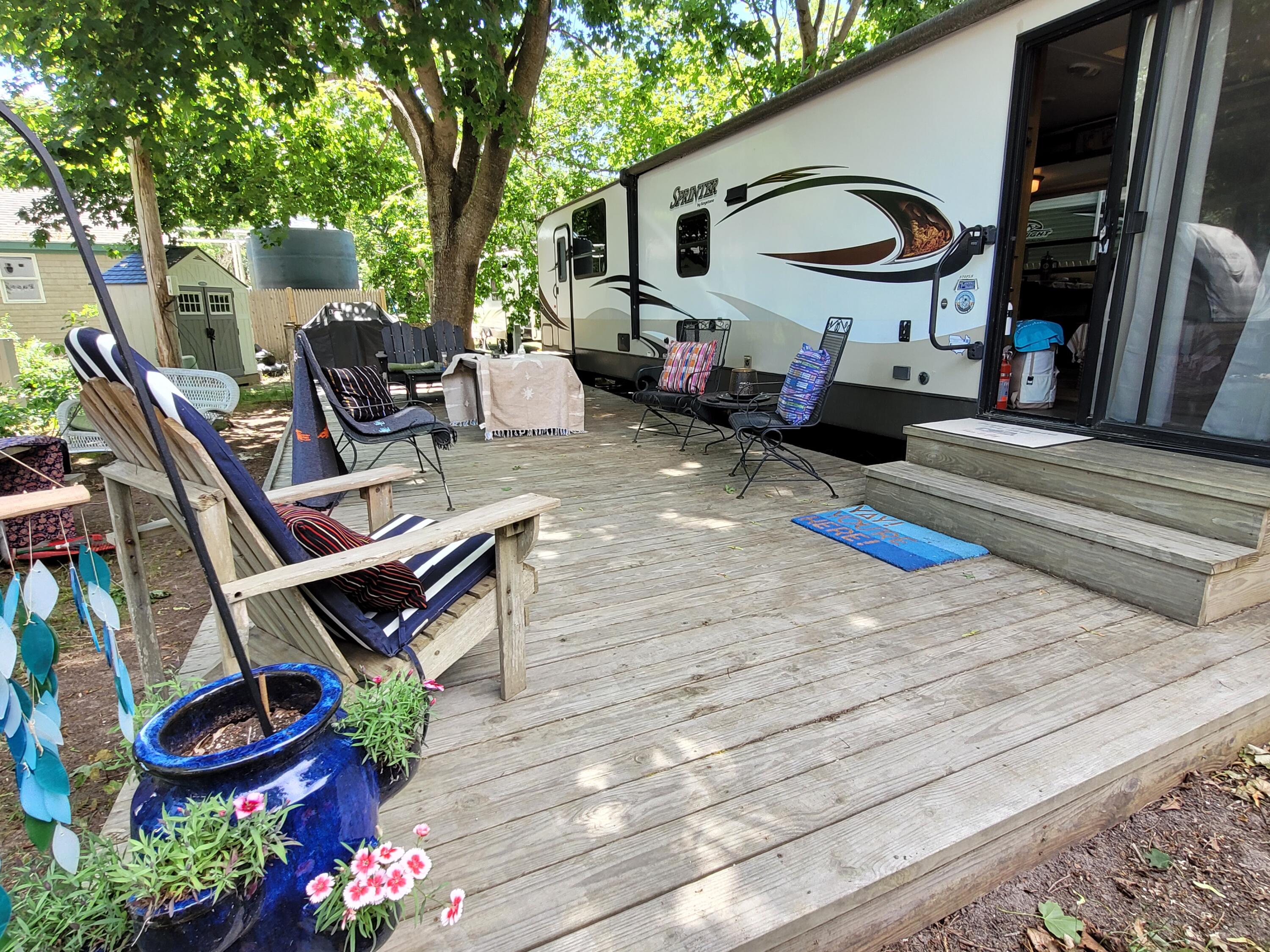 71 South Highland Road, Unit 1 Truro, MA 02666 - Photo 29 of 51 a backyard of a house with barbeque oven table and chairs