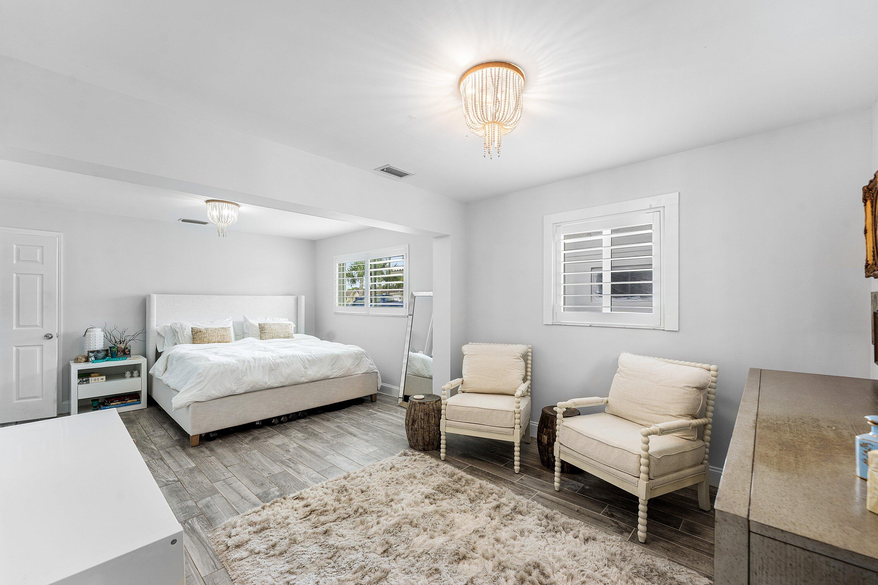 581 Northwest 13th Drive Boca Raton, FL 33486 - Photo 25 of 39 a bedroom with a bed and a couch