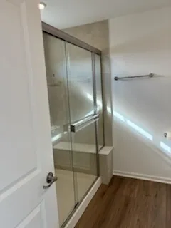 a bathroom with a glass shower door