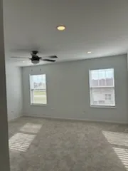 an empty room with a empty space and windows