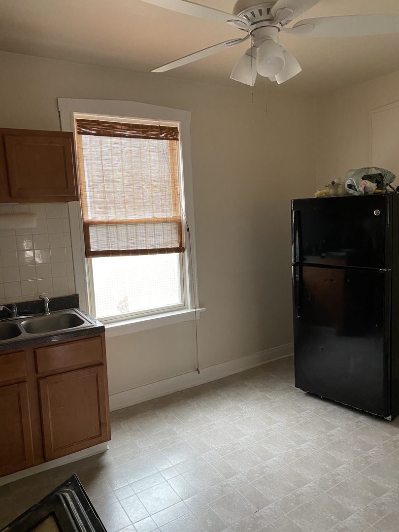 6546 South Rockwell Street, Unit 2 Chicago, IL 60629 - Photo 11 of 25 a kitchen with a refrigerator and a stove top oven