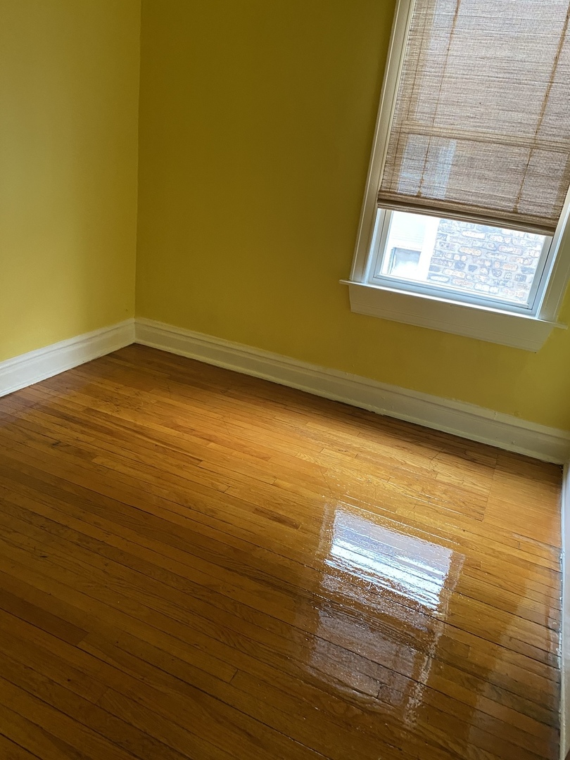 6546 South Rockwell Street, Unit 2 Chicago, IL 60629 - Photo 18 of 25 a view of a room with wooden floor and windows