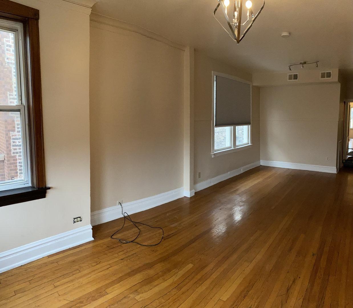 6546 South Rockwell Street, Unit 2 Chicago, IL 60629 - Photo 24 of 25 a view of an empty room with wooden floor and a window