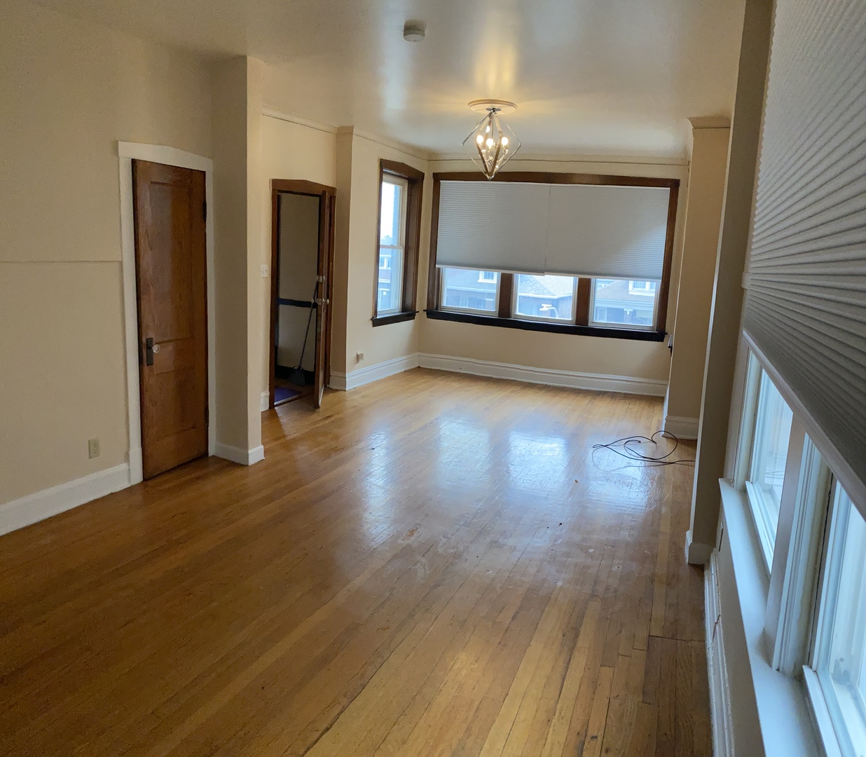 6546 South Rockwell Street, Unit 2 Chicago, IL 60629 - Photo 25 of 25 a view of an empty room with wooden floor and a kitchen