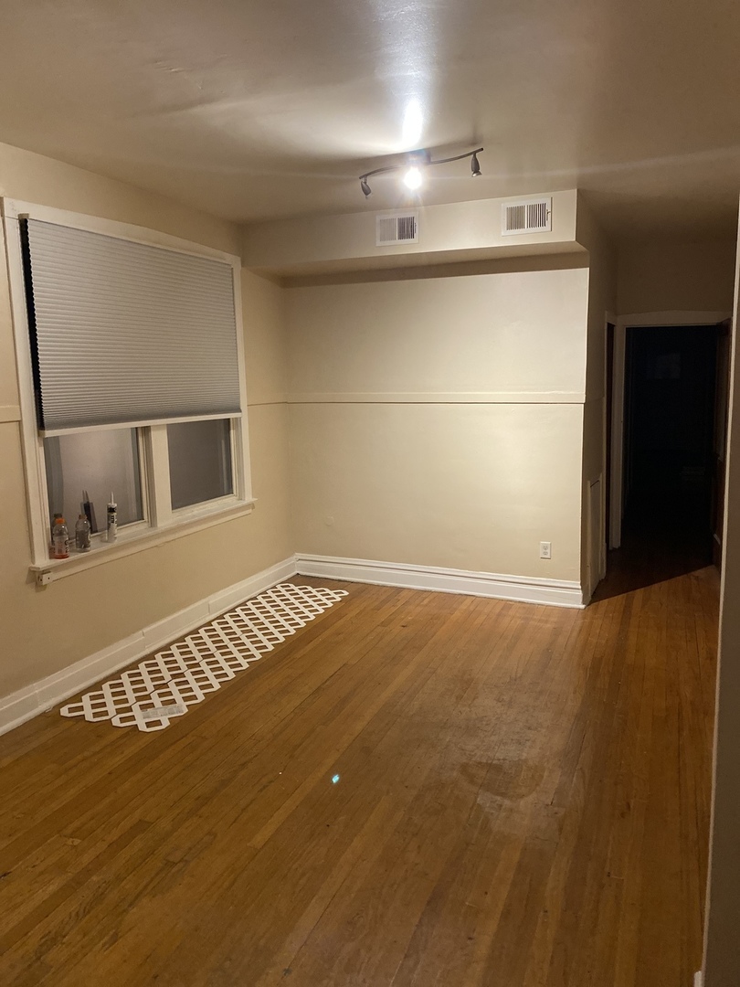 6546 South Rockwell Street, Unit 2 Chicago, IL 60629 - Photo 4 of 25 a view of an empty room with wooden floor