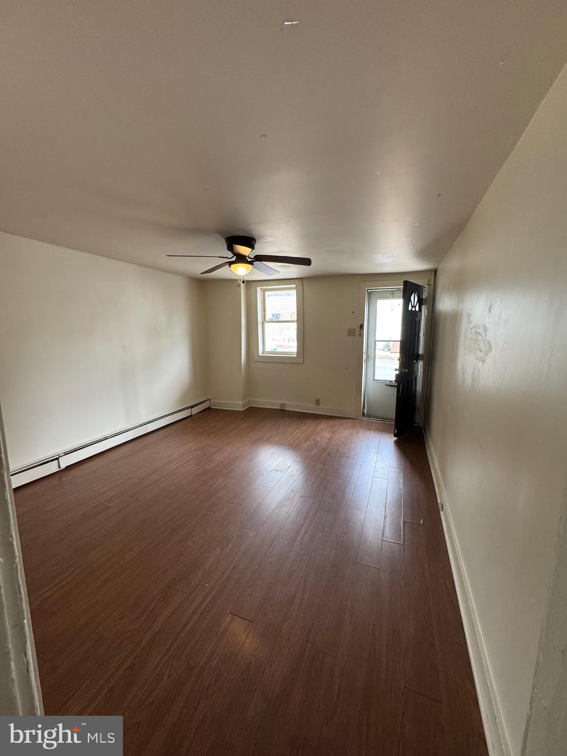 362 South 3rd Street Columbia, PA 17512 - Photo 2 of 14 an empty room with wooden floor and windows