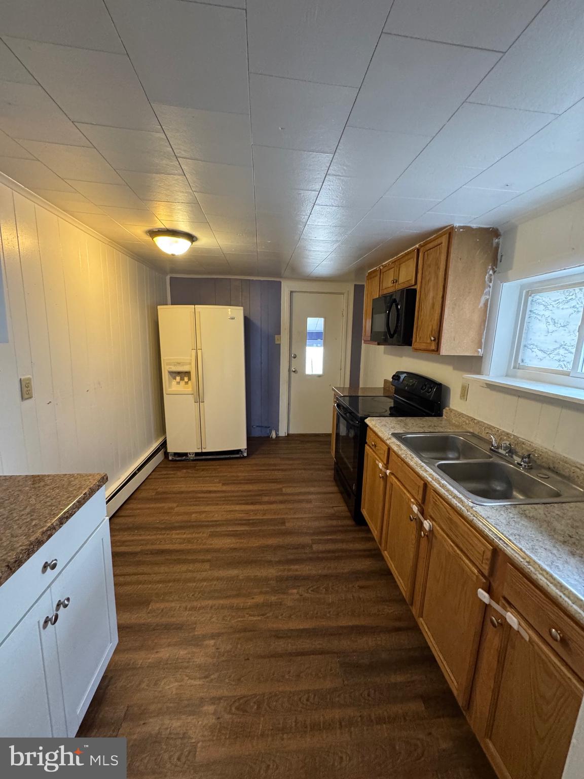 362 South 3rd Street Columbia, PA 17512 - Photo 6 of 14 a kitchen with granite countertop white cabinets and white appliances