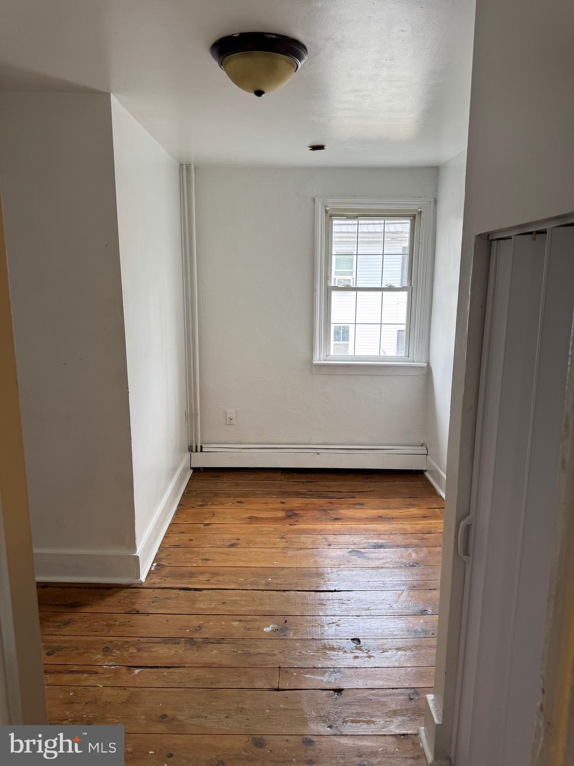 362 South 3rd Street Columbia, PA 17512 - Photo 8 of 14 an empty room with wooden floor and windows