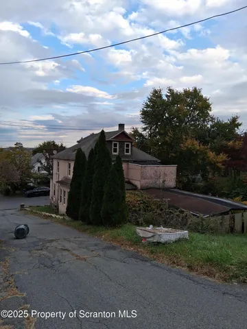 a view of a street with a building in the background