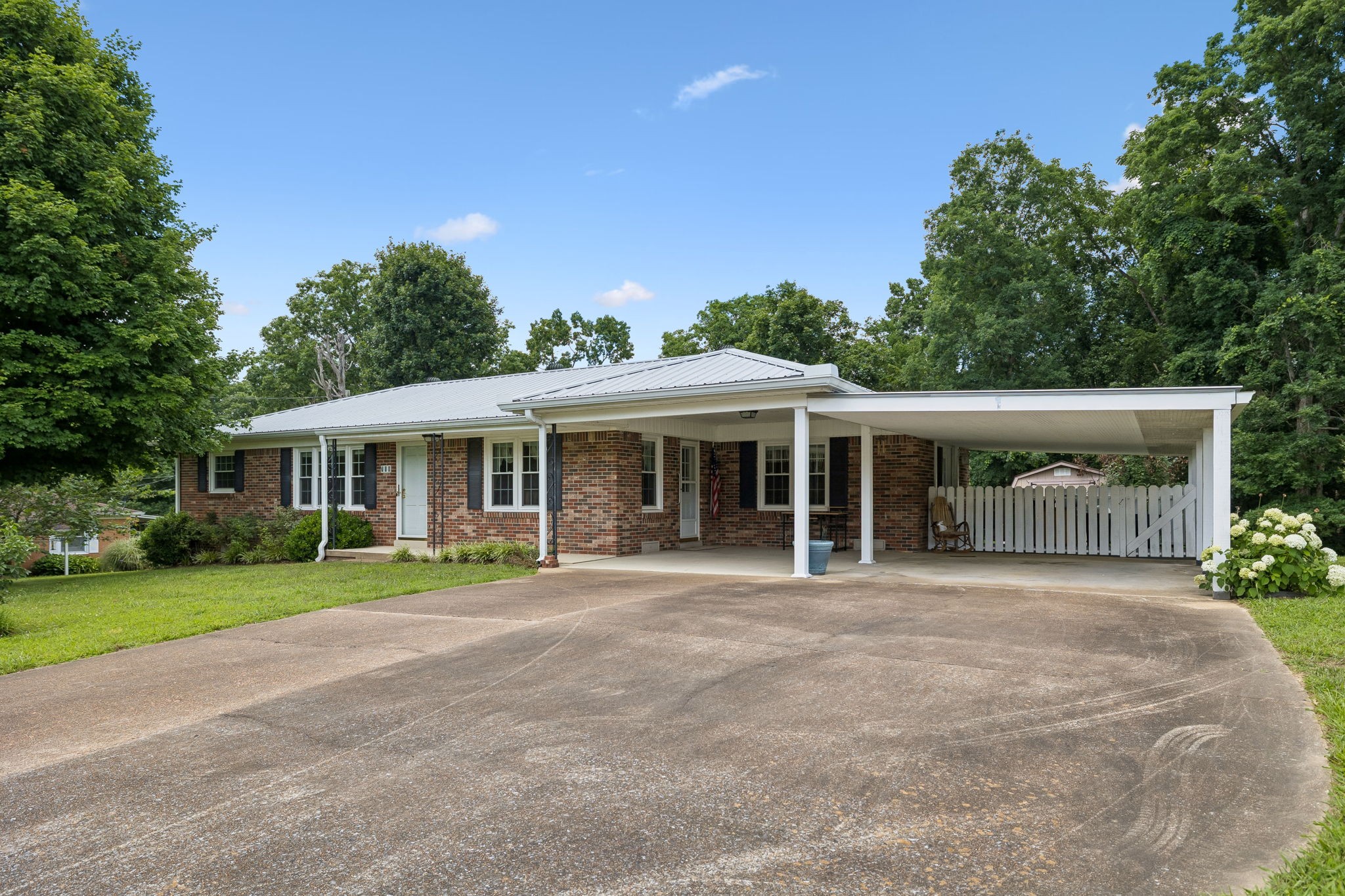 708 Hickory Street Centerville, TN 37033 - Photo 3 of 57 a front view of a house with a garden