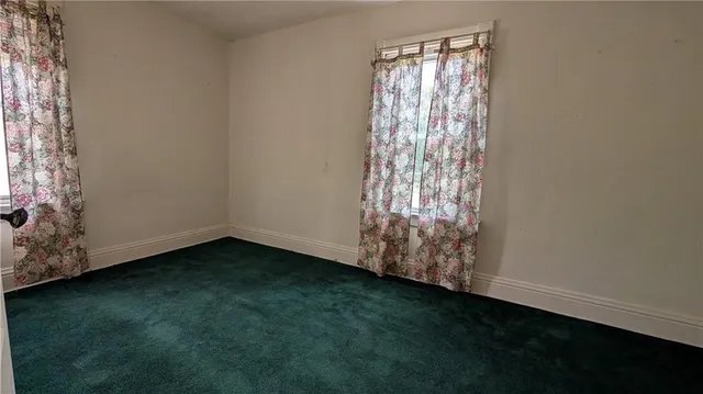 a view of room with window and hardwood floor