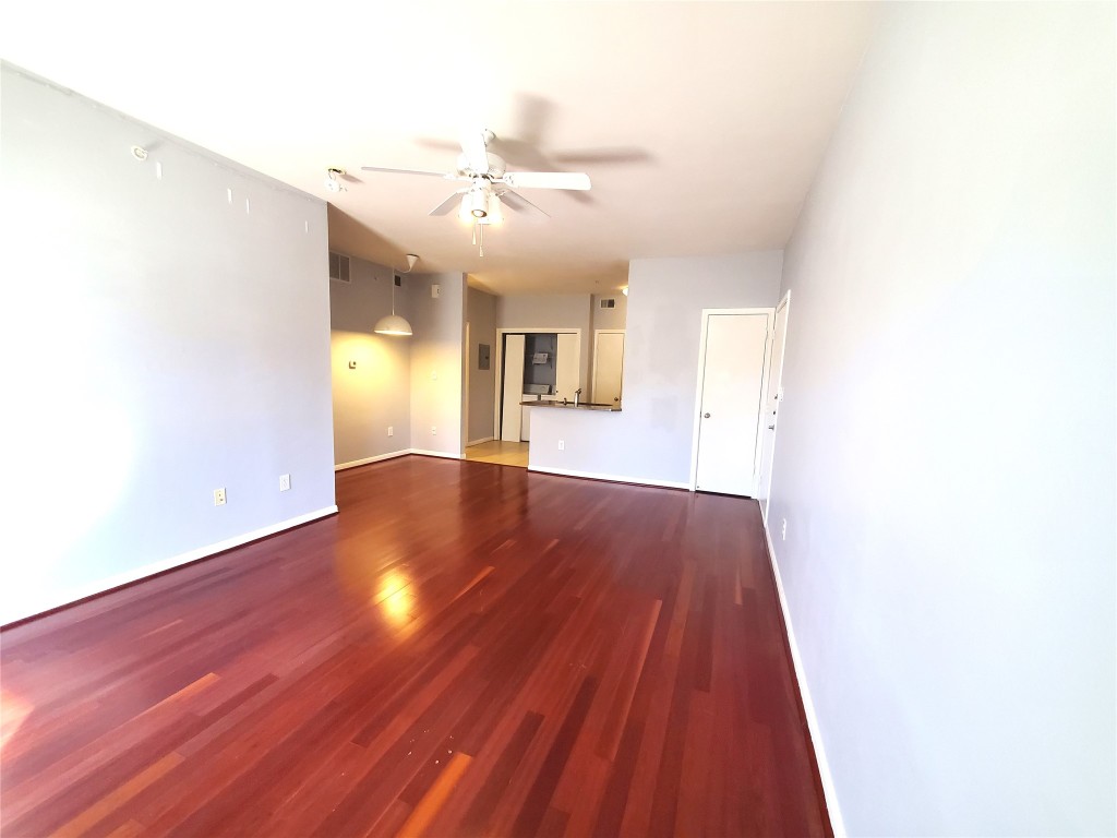 2209 Hancock Drive, Unit 16 Austin, TX 78756 - Photo 5 of 20 a view of an empty room with wooden floor