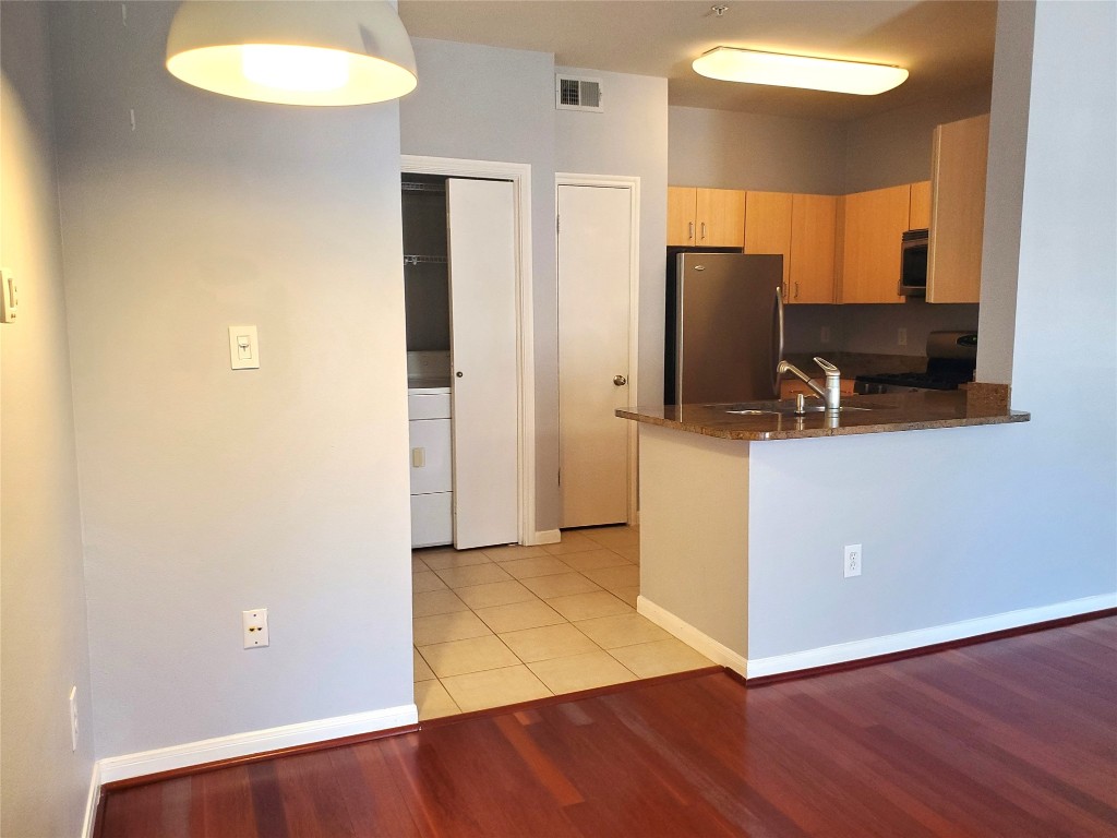 2209 Hancock Drive, Unit 16 Austin, TX 78756 - Photo 6 of 20 an empty room with wooden floor and windows