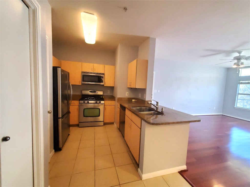 2209 Hancock Drive, Unit 16 Austin, TX 78756 - Photo 8 of 20 a kitchen with stainless steel appliances granite countertop a stove and a refrigerator