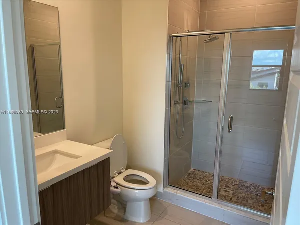 a bathroom with a shower and toilet
