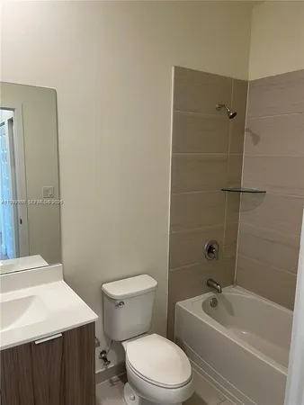 a bathroom with a toilet a sink and bathtub