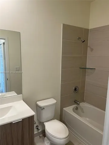 a bathroom with a toilet a sink and bathtub