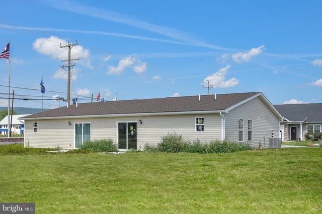 a front view of house with a garden