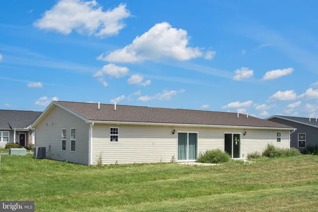 a front view of house with yard and green space