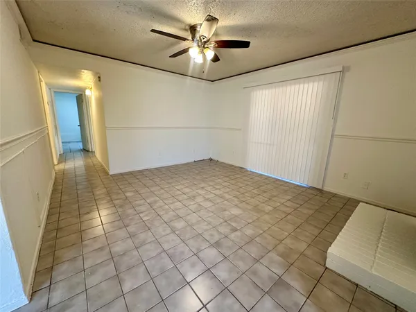 a view of a livingroom with an empty space and a ceiling fan