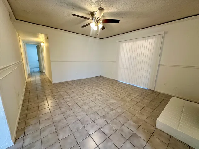 a view of a livingroom with an empty space and a ceiling fan