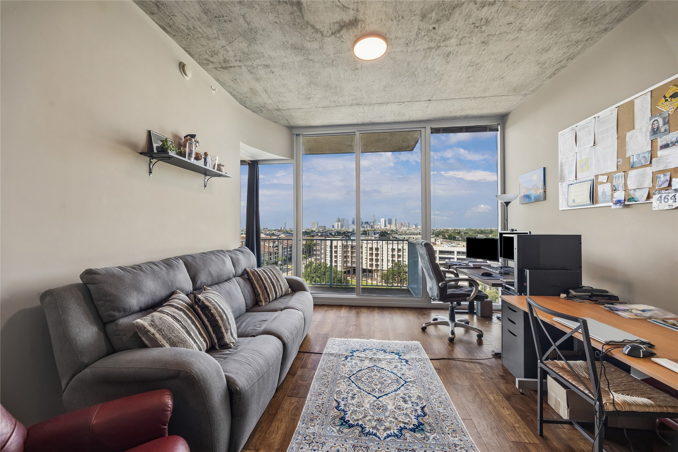 5925 Almeda Road, Unit 11011 Houston, TX 77004 - Photo 7 of 24 Welcome to 10th floor living! North facing unit with lovely downtown view in the distance. Warm wood floors anchor the room and full wall offers more privacy for the bedroom. Many other units in the building only have a 3/4 height wall. Living area provides lots of work space if needed.