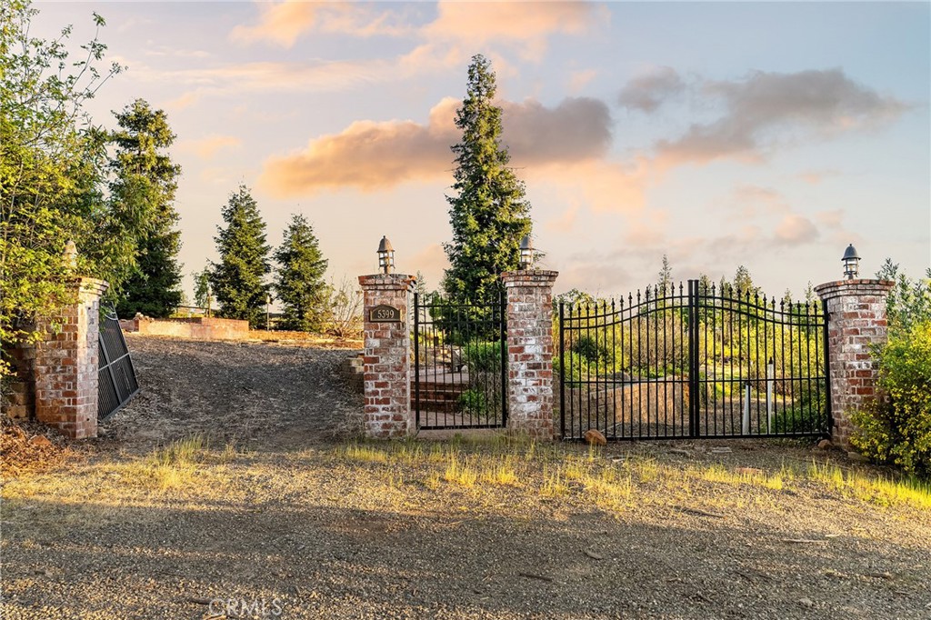5399 Newland Road Paradise, CA 95969 - Photo 2 of 27 a view of a pathway with a wrought fence