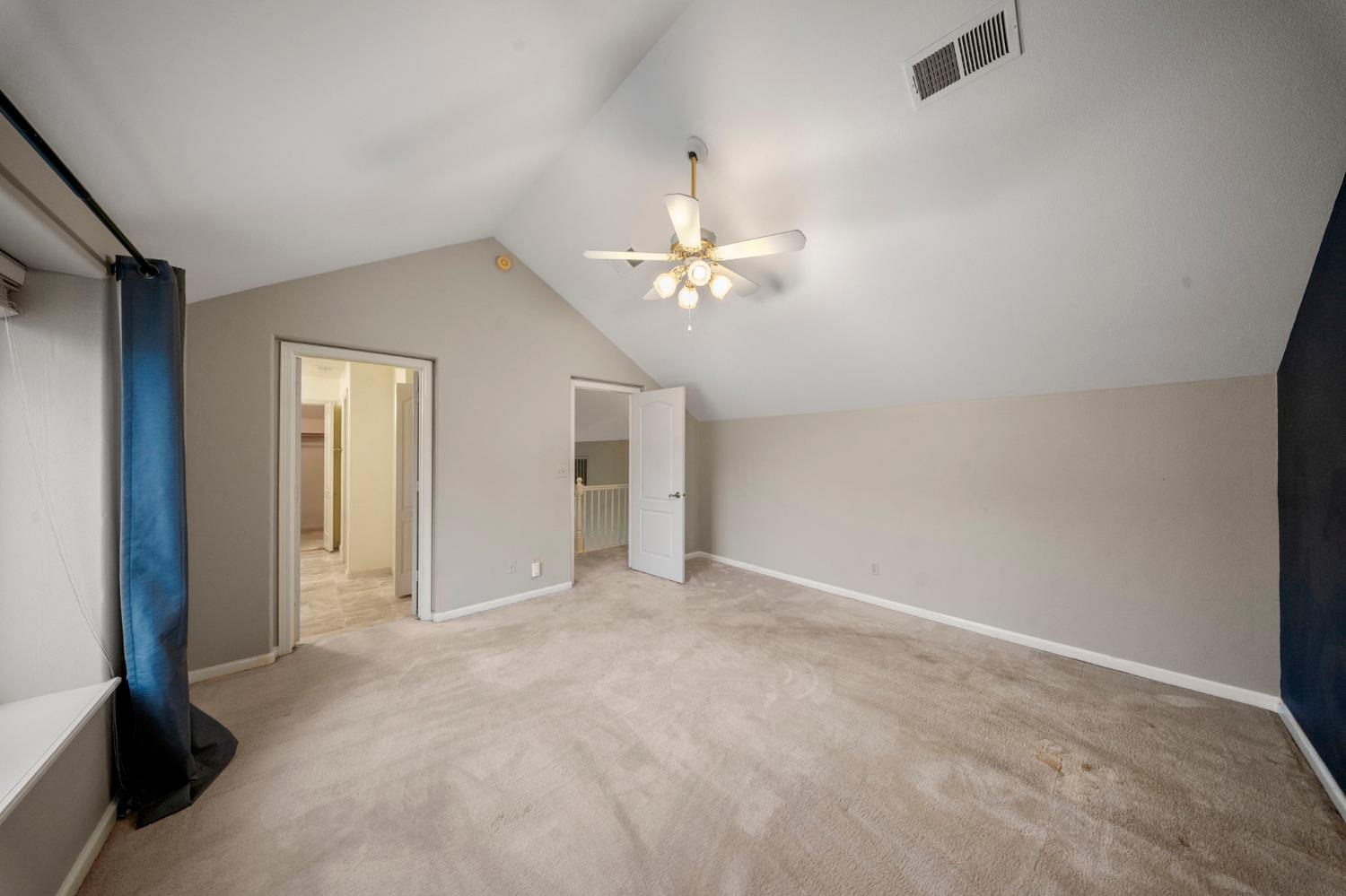 1128 Valencia Court Modesto, CA 95350 - Photo 17 of 30 a view of an empty room with a ceiling fan