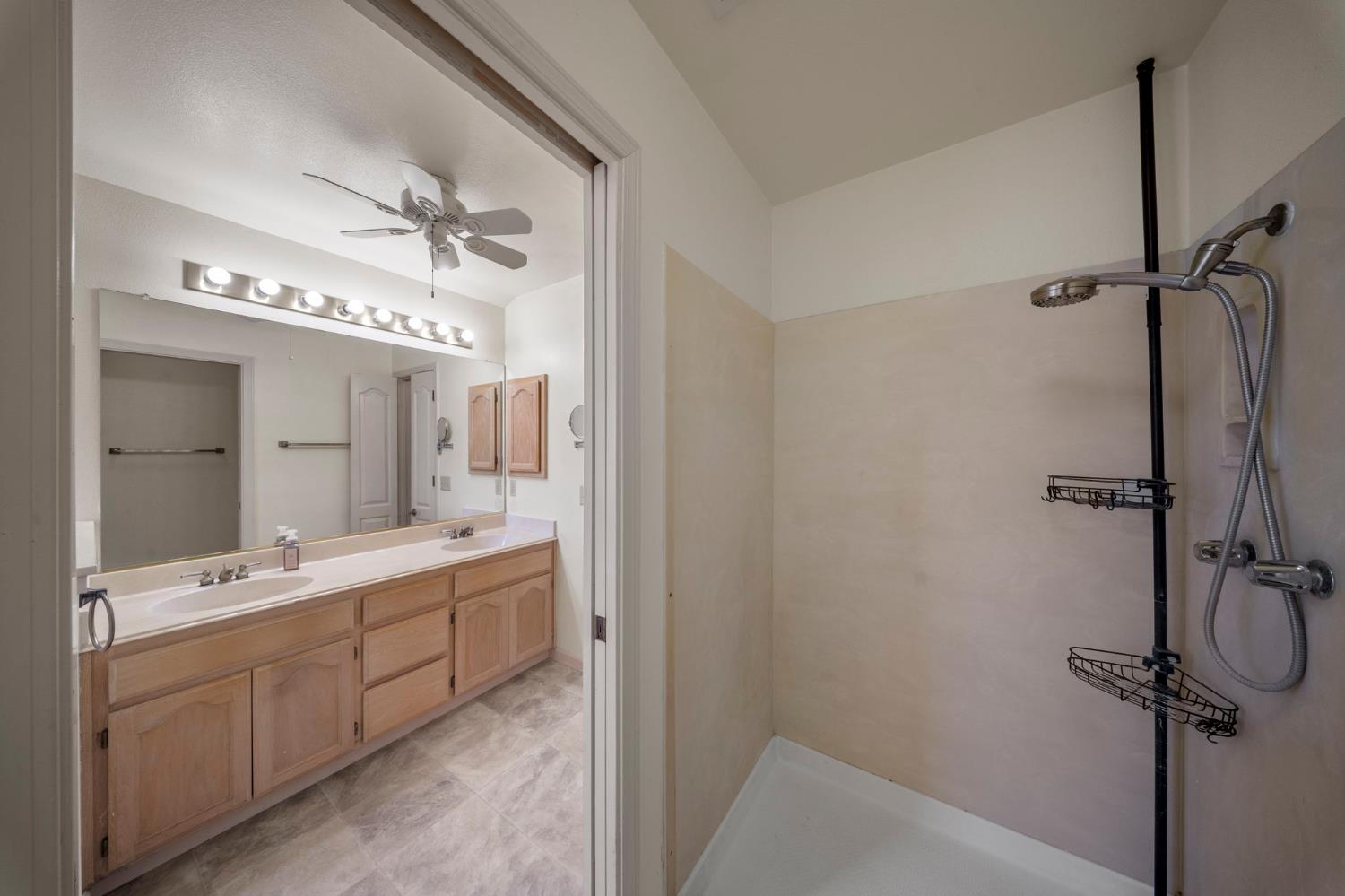 1128 Valencia Court Modesto, CA 95350 - Photo 19 of 30 a bathroom with a double vanity sink mirror and bathtub