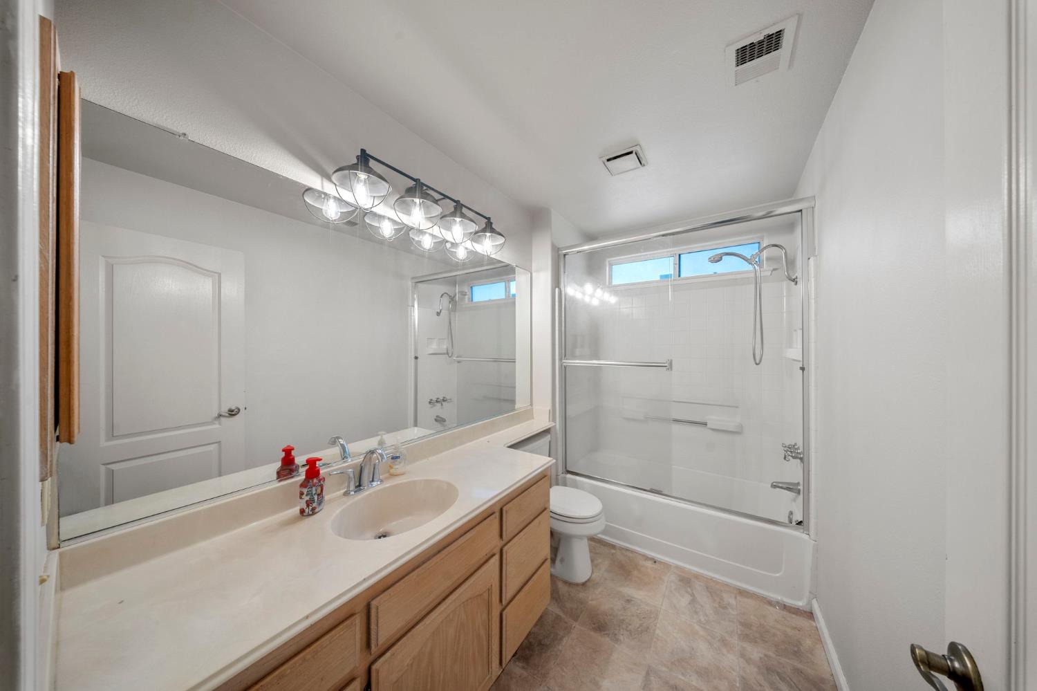1128 Valencia Court Modesto, CA 95350 - Photo 22 of 30 a bathroom with a bathtub shower sink mirror and toilet