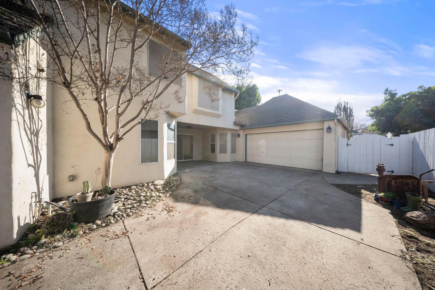 1128 Valencia Court Modesto, CA 95350 - Photo 28 of 30 a front view of a house with a yard and garage