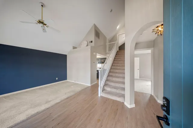 a view of entryway and hall with wooden floor