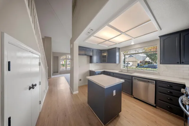 a large kitchen with stainless steel appliances granite countertop a lot of counter space and wooden floor