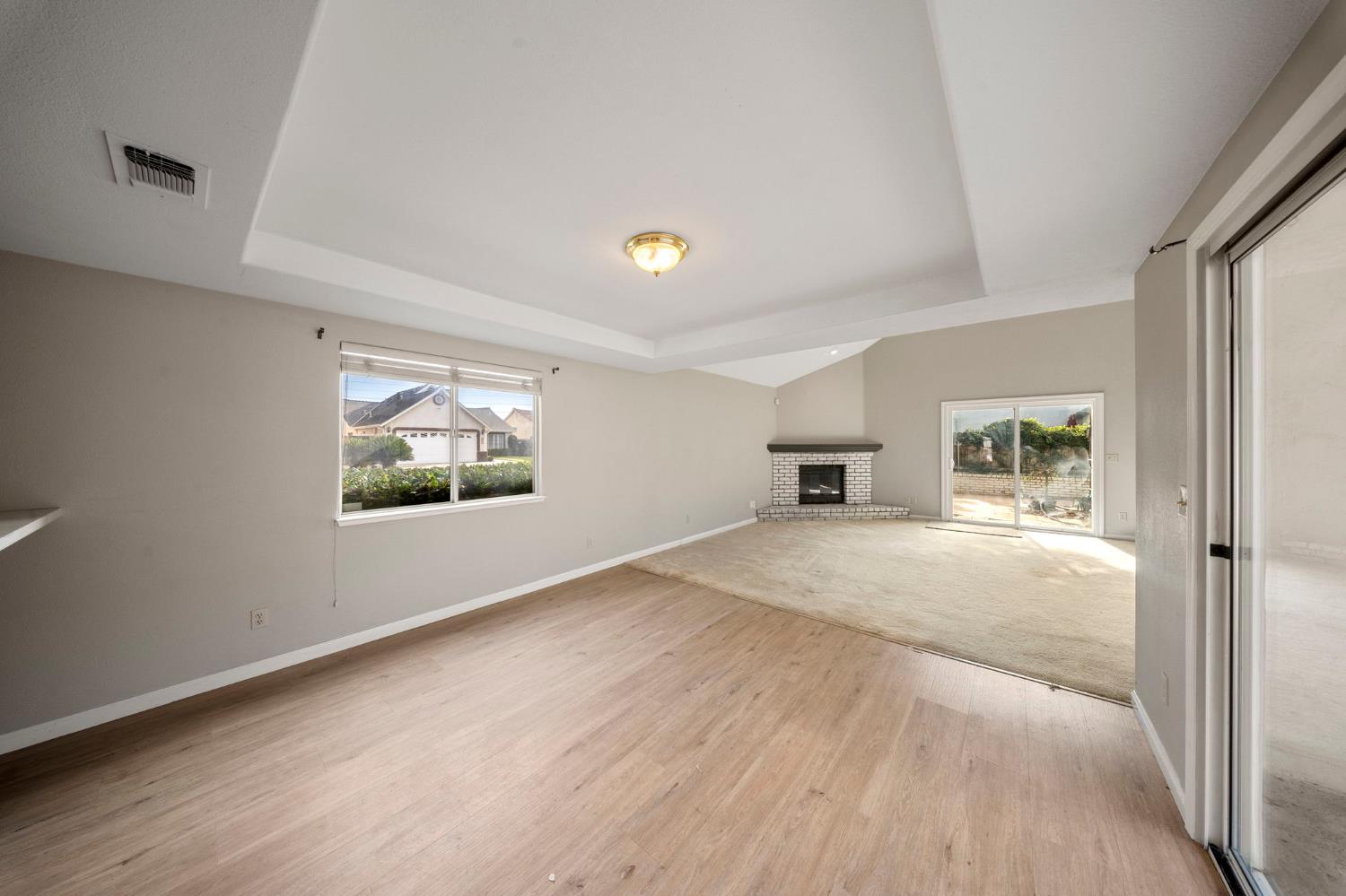 1128 Valencia Court Modesto, CA 95350 - Photo 9 of 30 a view of empty room with wooden floor and window