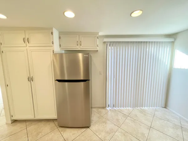 a white refrigerator freezer sitting in a kitchen