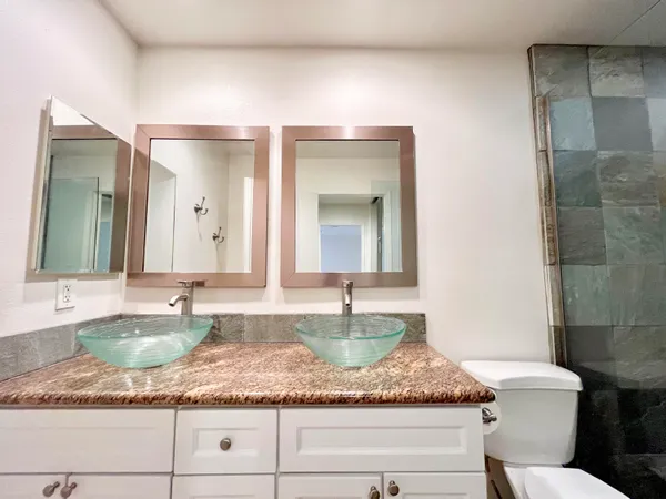 a bathroom with a granite countertop sink and a mirror
