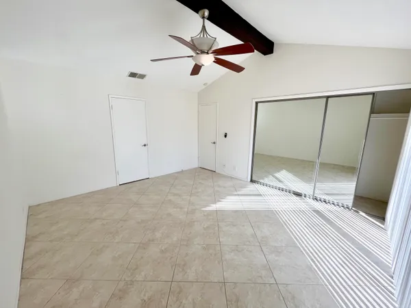 a view of an empty room with a ceiling fan