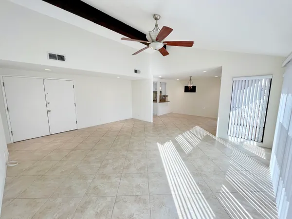 a view of a livingroom with a ceiling fan and wooden floor