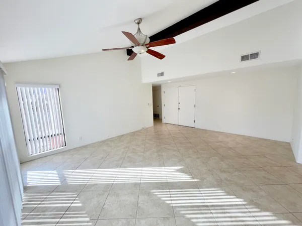 a view of a livingroom with a ceiling fan and window
