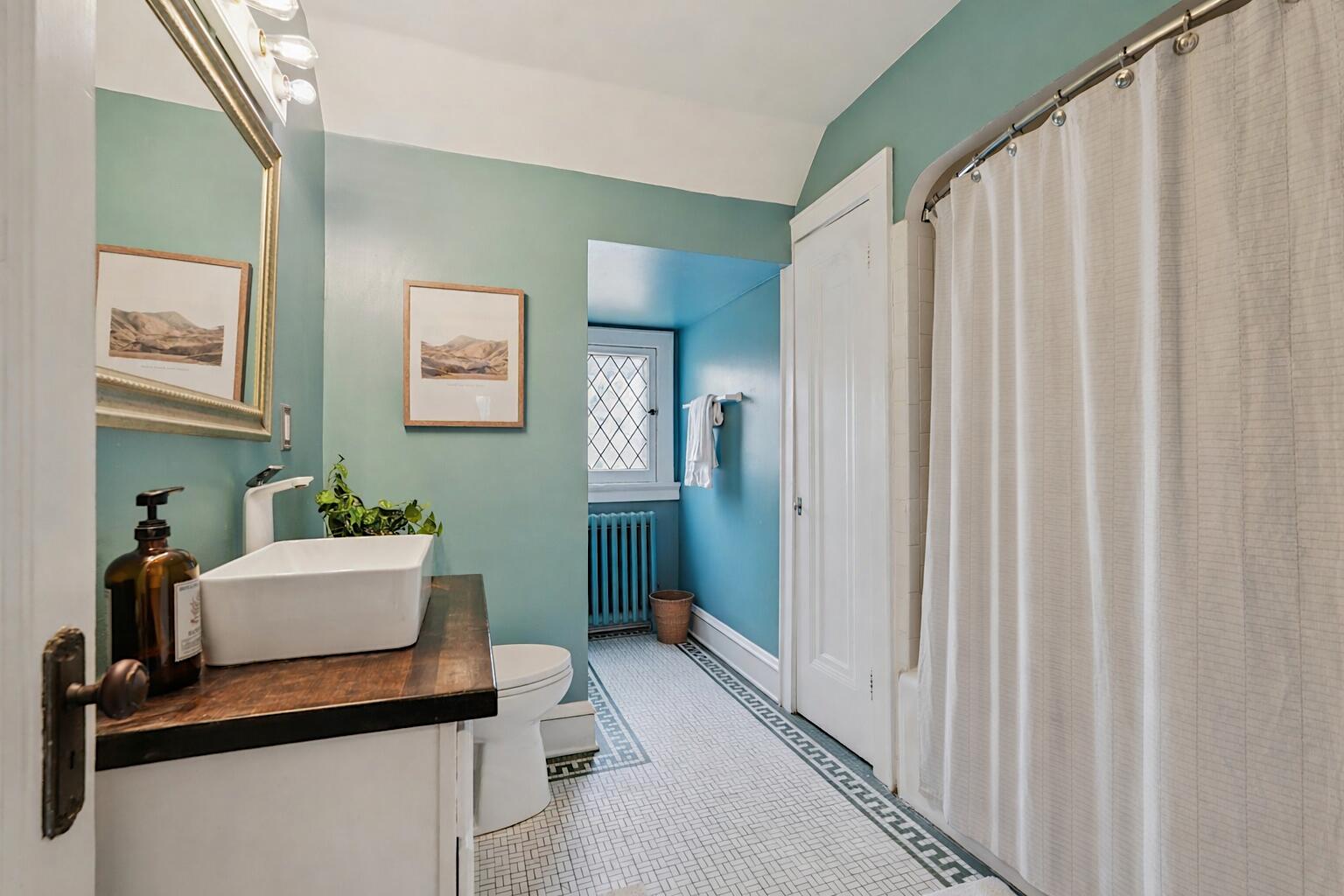 5671 North Bay Ridge Avenue Whitefish Bay, WI 53217 - Photo 21 of 39 Extra large bathroom with leaded-glass window, linen closet, and classic floor tile colors and patterns.