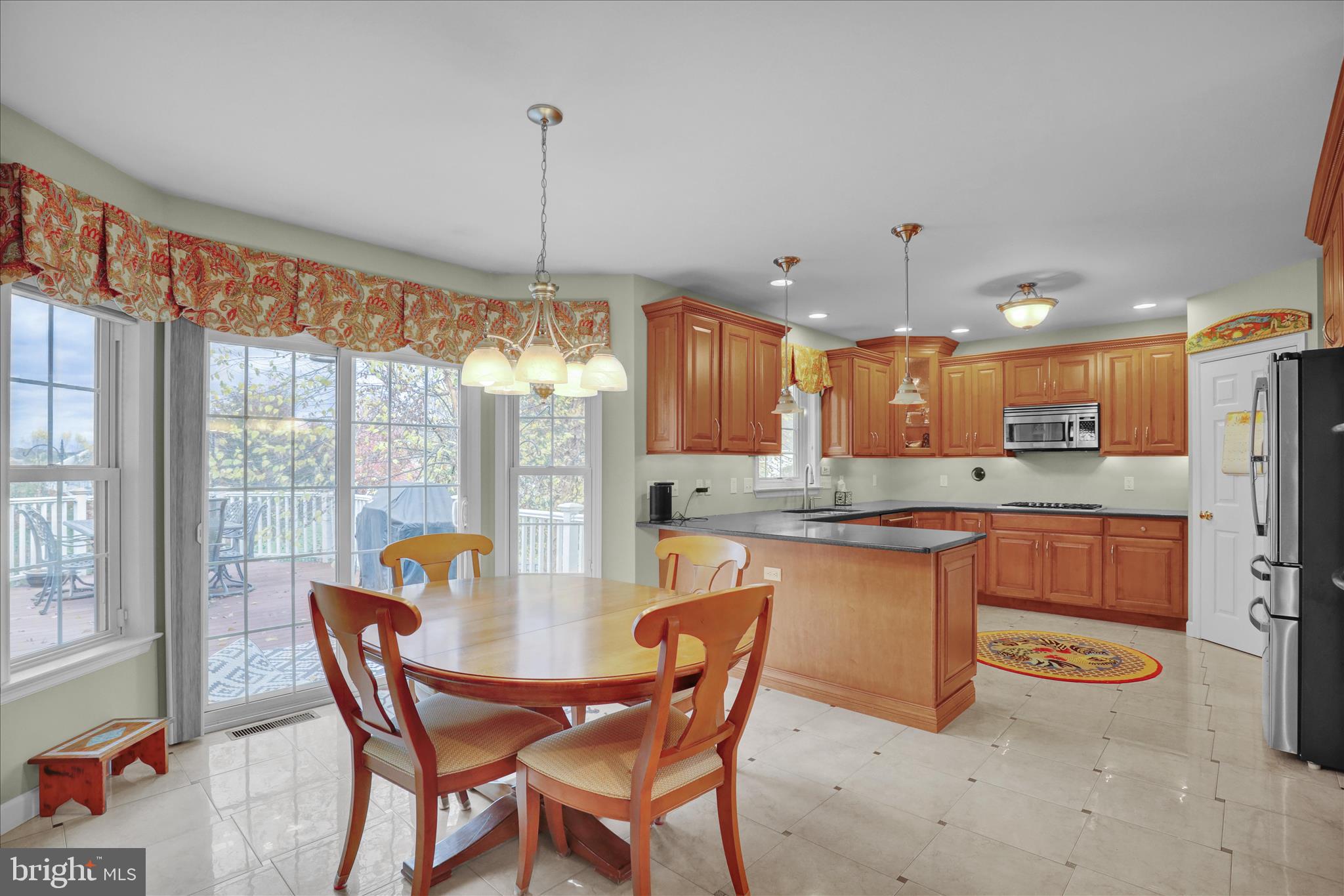 35 Pacific Avenue Sinking Spring, PA 19608 - Photo 16 of 63 a kitchen with stainless steel appliances granite countertop a table chairs and a refrigerator
