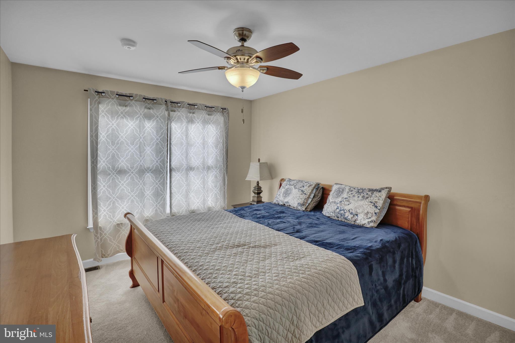 35 Pacific Avenue Sinking Spring, PA 19608 - Photo 41 of 63 a bedroom with a large bed and a chandelier